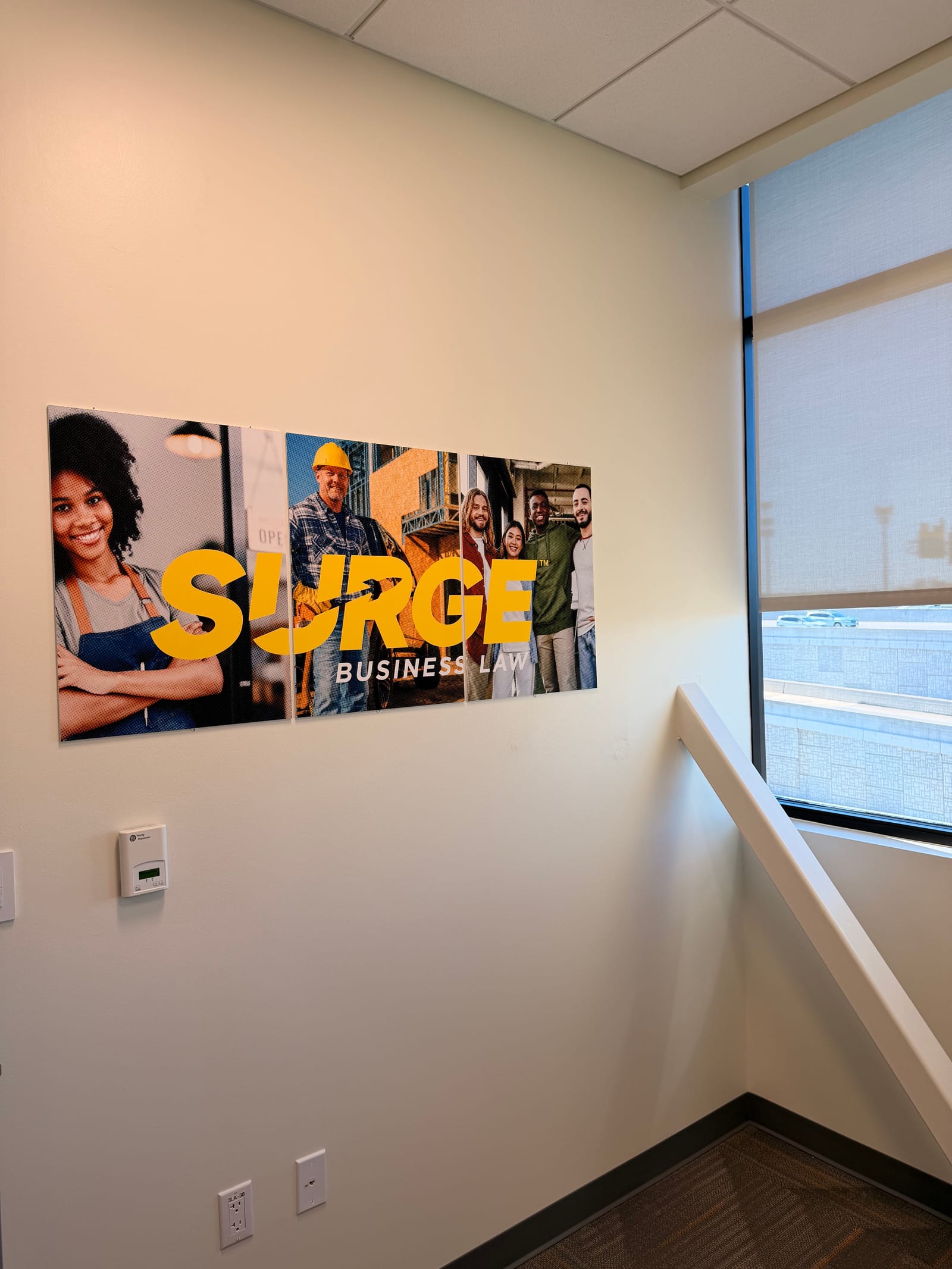 Surge Business Law branded wall display in the Texas office